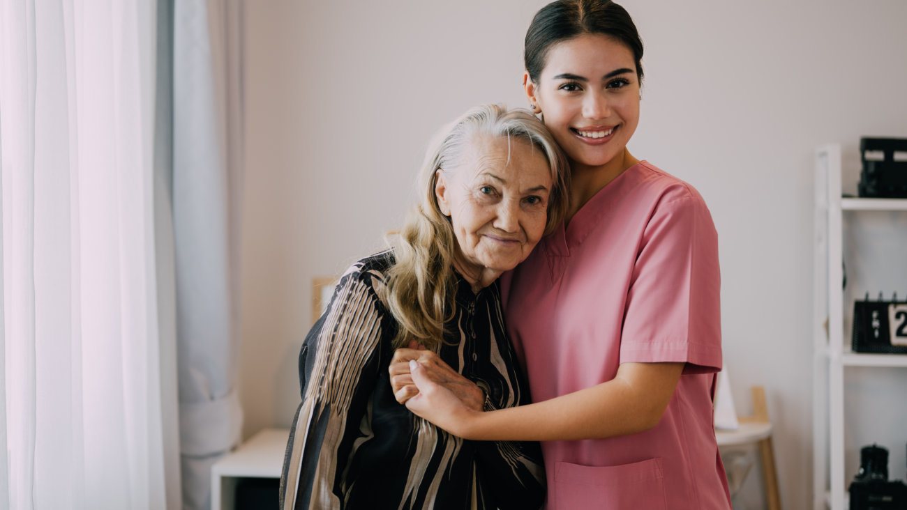 senior patient and the caregiver smiling