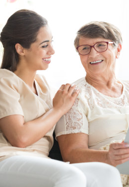 senior woman and the caregiver smiling