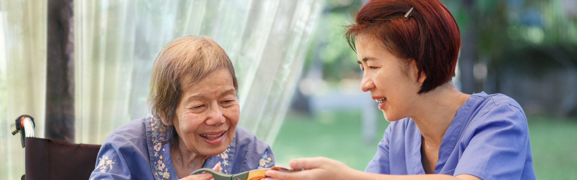 Elderly women with caregiver are in the needle crafts occupational therapy